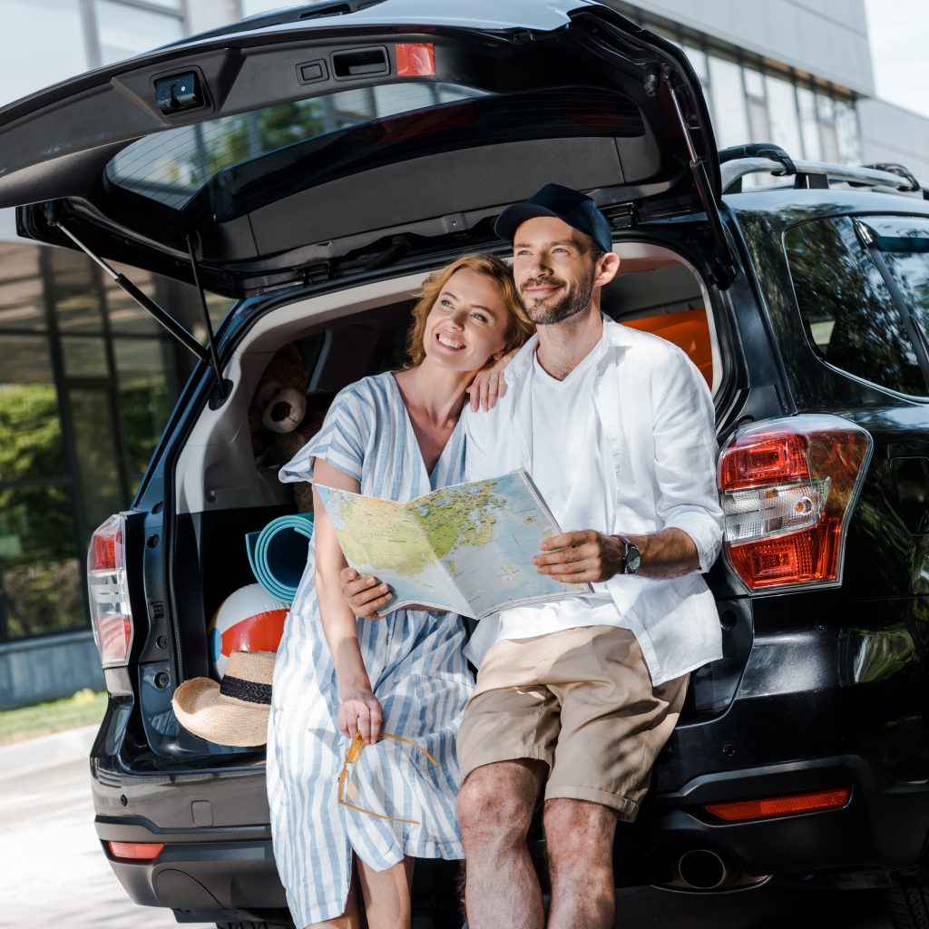 couple planning road trip adventure from car trunk 2026 03 25 22 33 40 utc