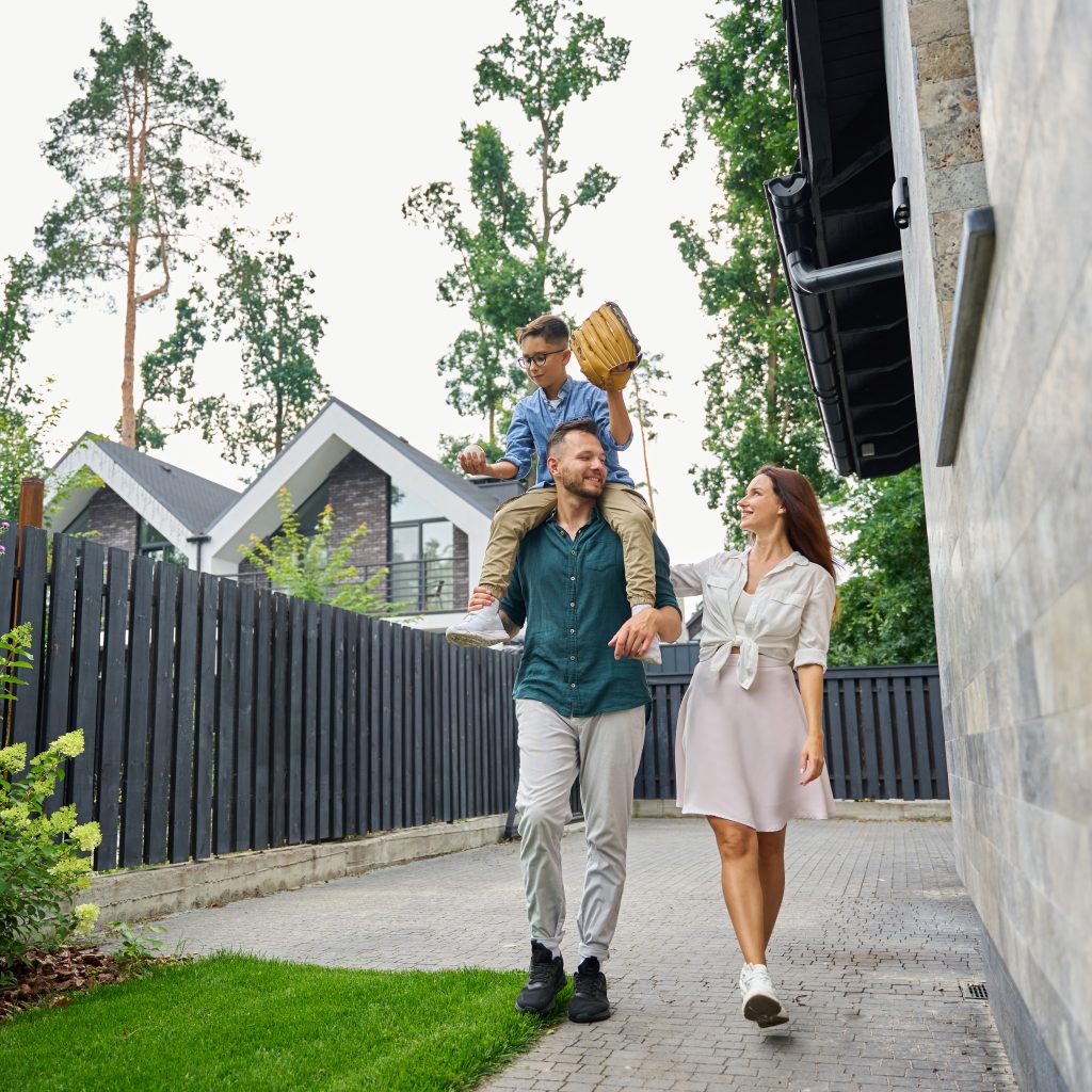 happy family walking along a suburban street 2026 01 08 06 54 51 utc