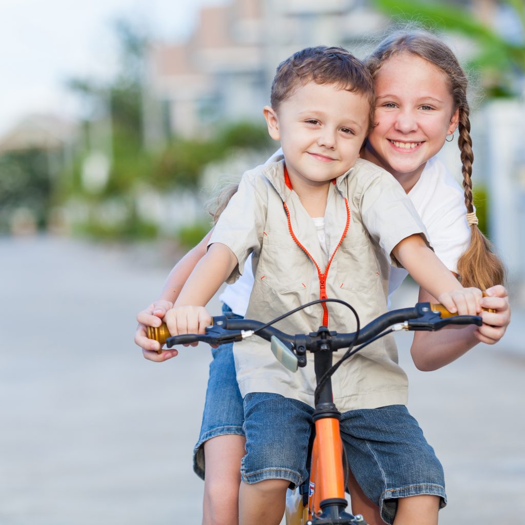 happy kids with bike standing on the road at the d 2026 01 05 01 04 37 utc